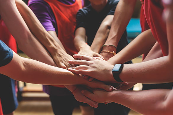 A sports team huddles at a game