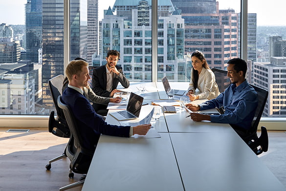 Employees attend a meeting in a high-rise skyscraper