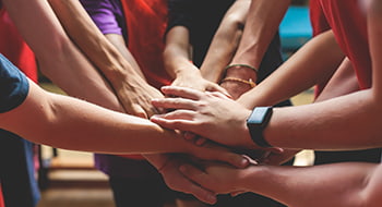 A sports team huddles at a game