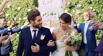 a bride and groom surrounded by their bridesmaids and groomsmen