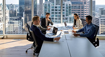 Employees meet in a conference room